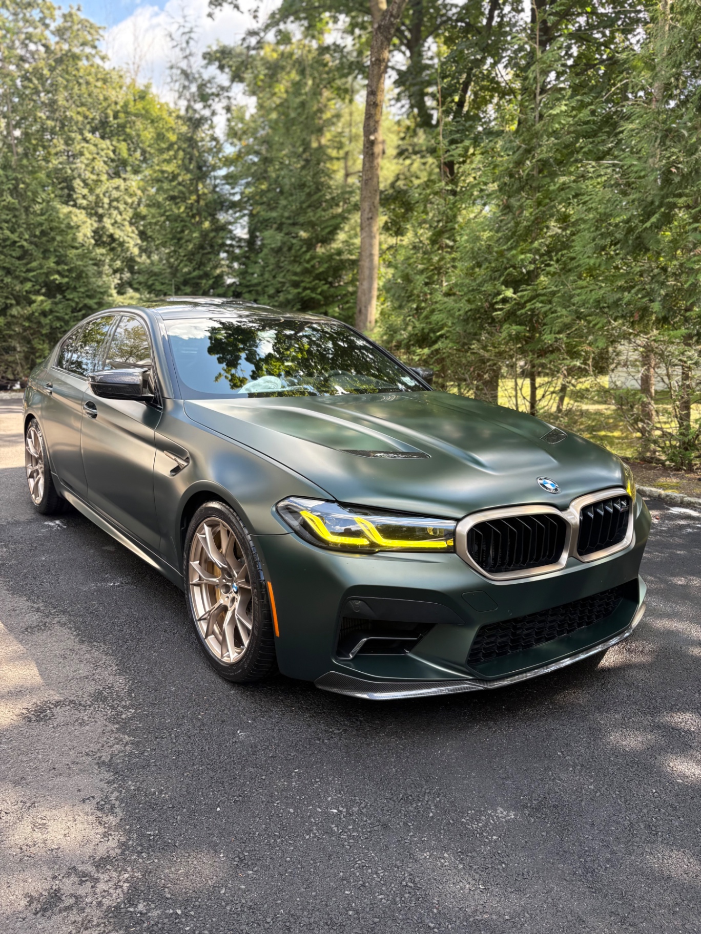 BMW M5 CS — Matte green, kept concours-quiet.